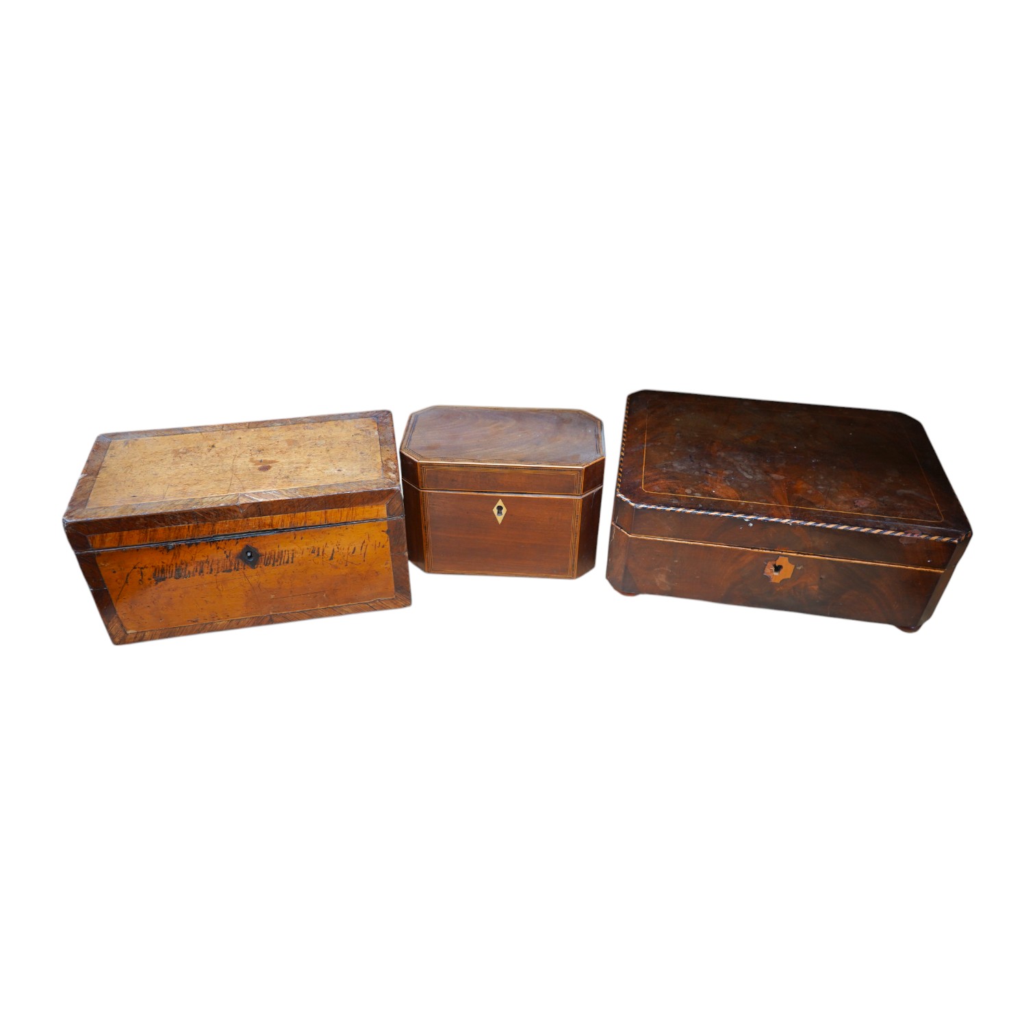 A 19th century mahogany work box and two tea caddies, largest work box 29cm wide, 20cm deep (3). Condition - poor to fair